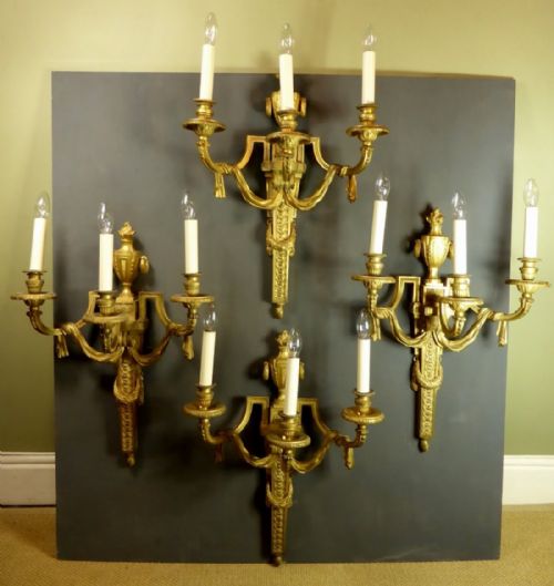 A Large and Substantial Set of Four 19th Century Gilt Brass Three Branch Wall Sconces