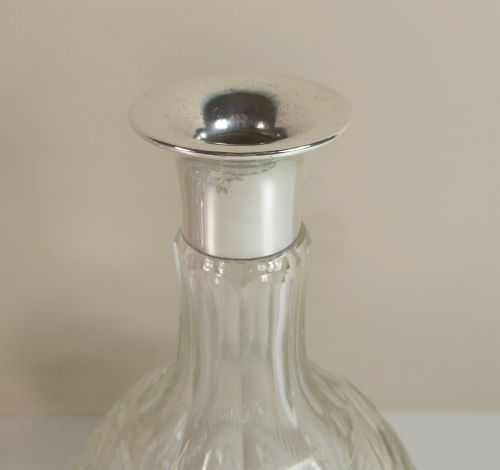 fig 1. PAIR OF CUT GLASS DECANTERS WITH SILVER COLLARS