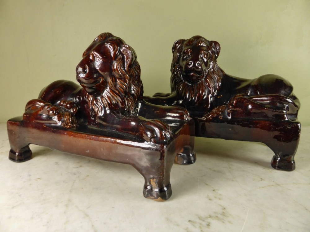 PAIR OF DERBYSHIRE TREACLE GLAZE LIONS