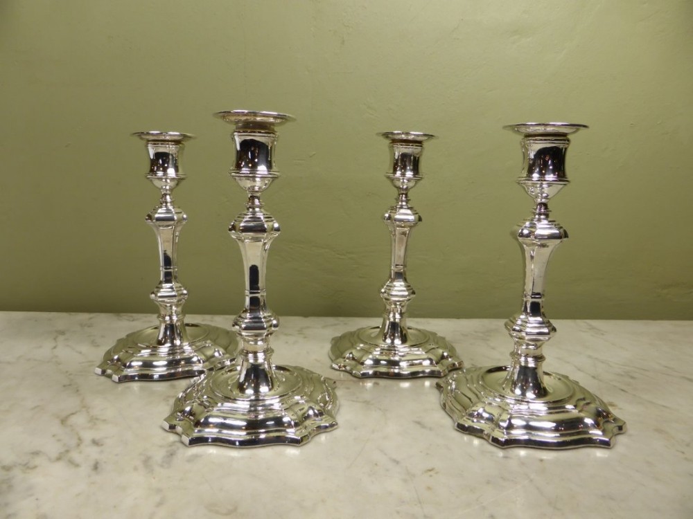SET OF FOUR SILVER CANDLESTICKS