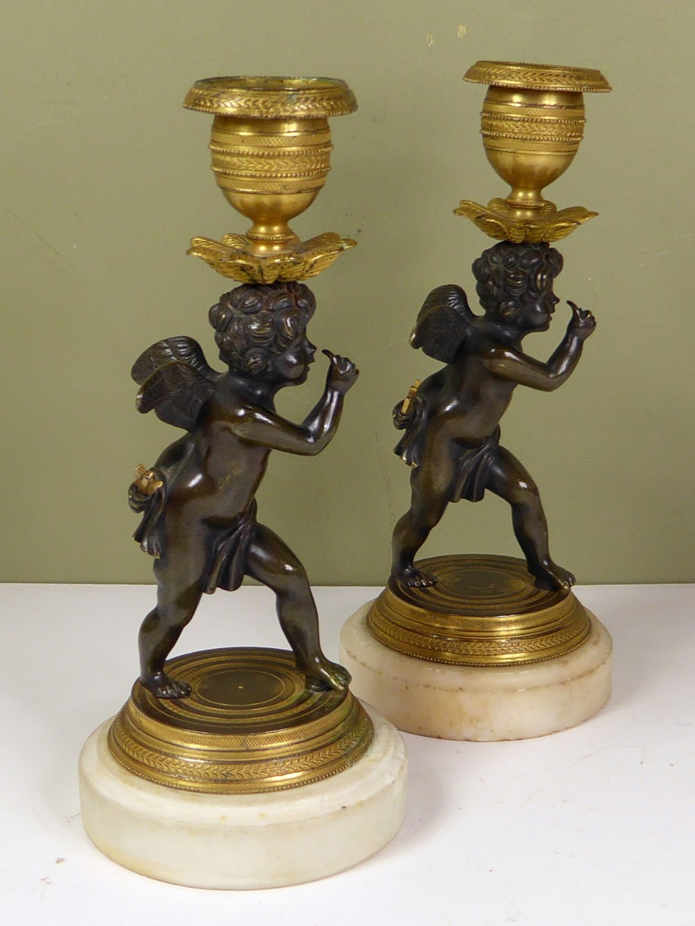 PAIR OF REGENCY CHERUB CANDLESTICKS