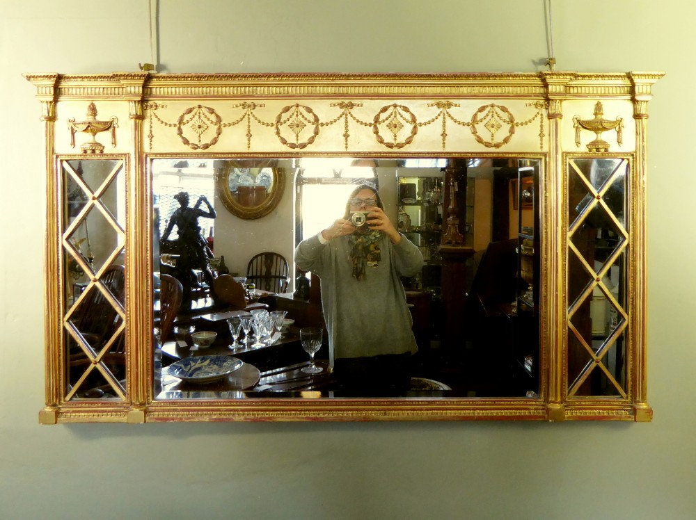 A GILT OVERMANTLE MIRROR
