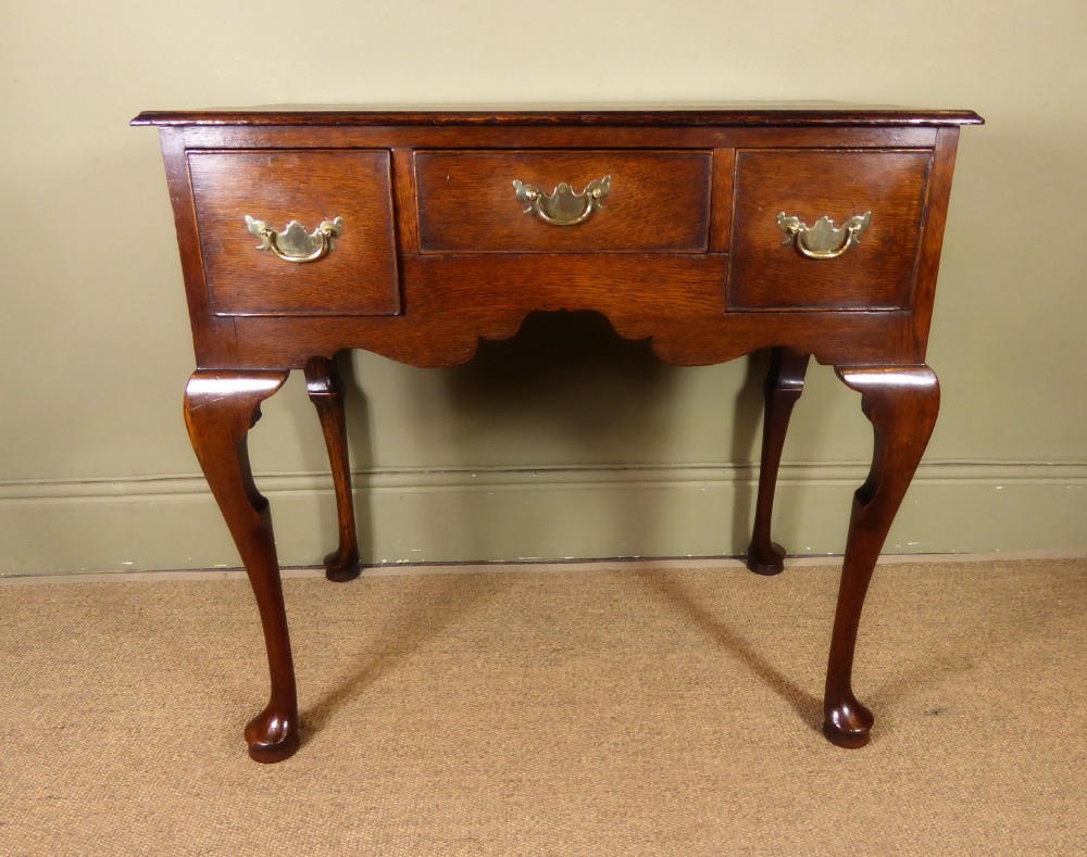 A GEORGE II OAK LOW BOY TABLE