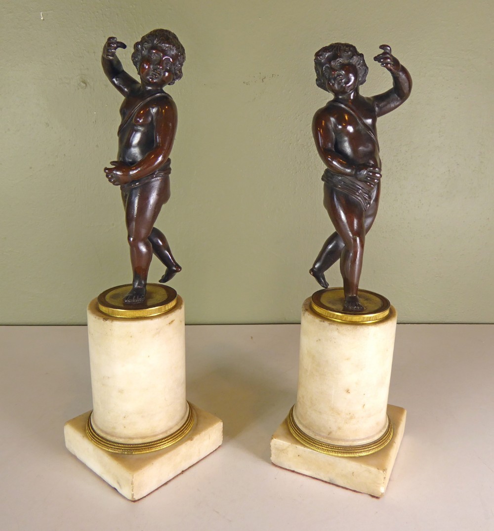 PAIR OF REGENCY BRONZE CHERUBS ON MARBLE BASES