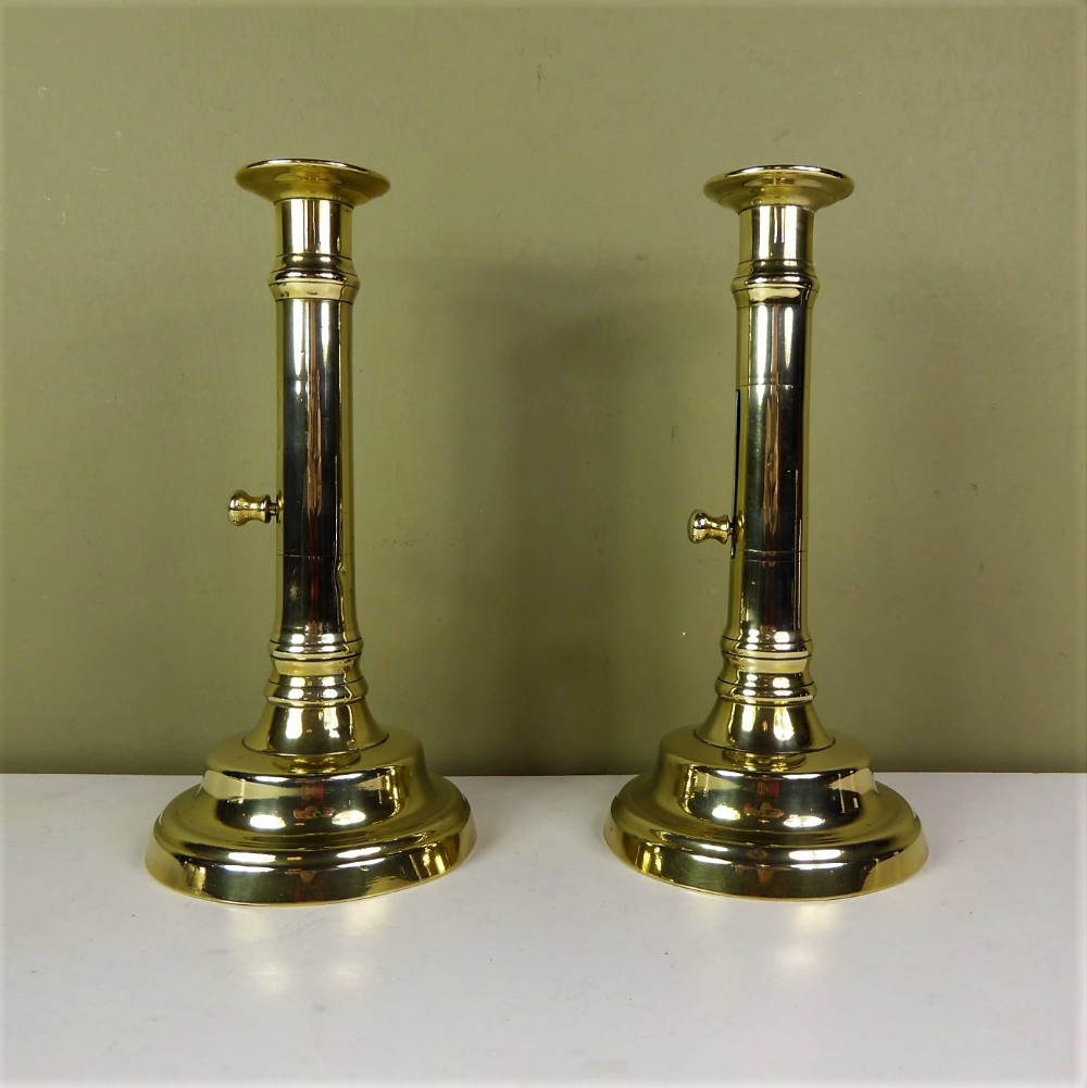 A PAIR OF BRASS CANDLE STICKS