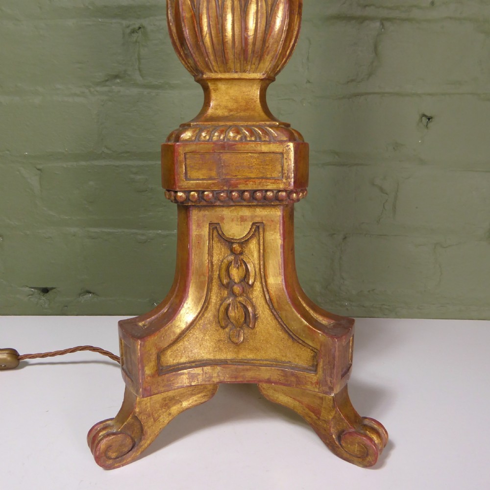 A tall 19th-century carved giltwood pricket candlestick converted into a table lamp base with a brass electrical fitting. View II