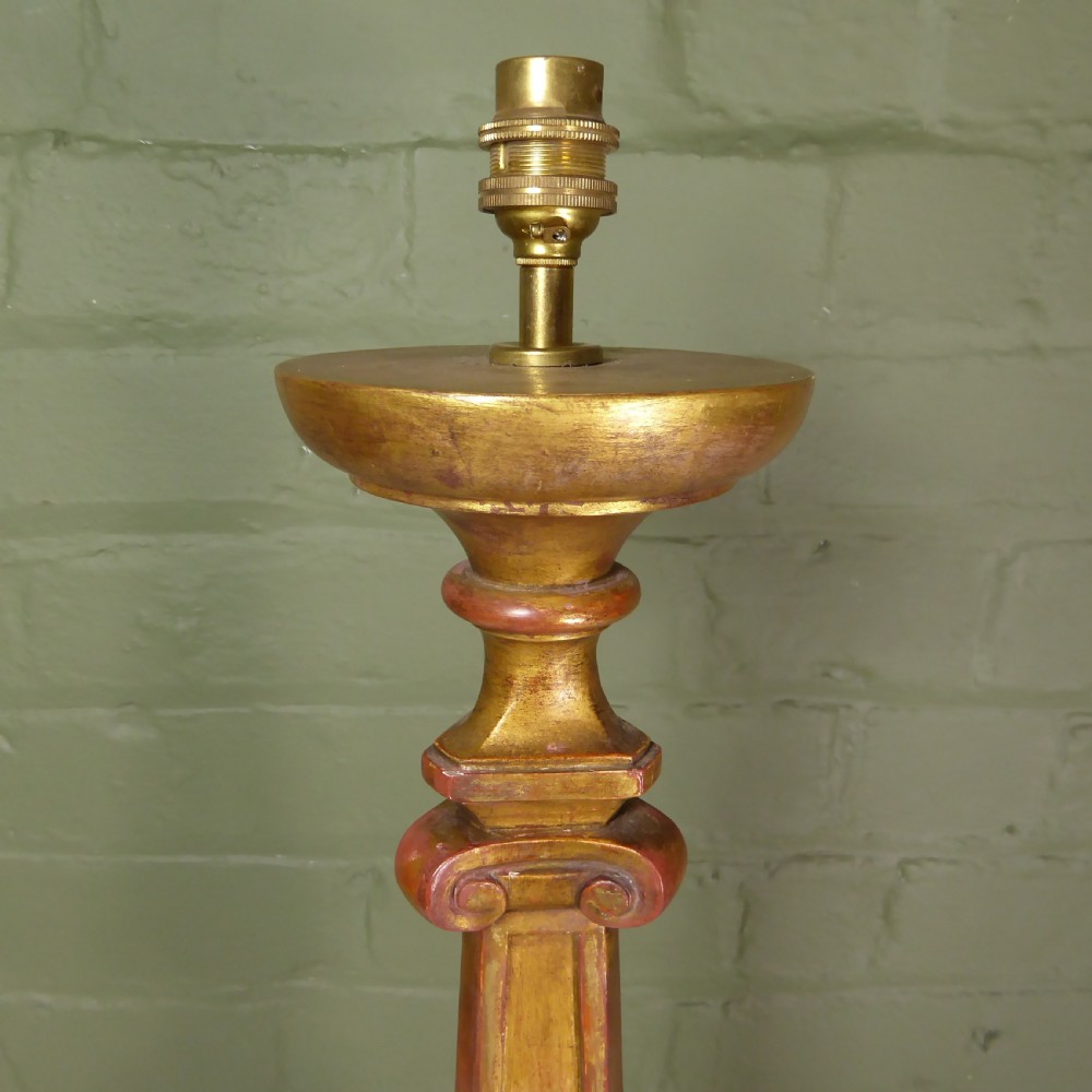 A tall 19th-century carved giltwood pricket candlestick converted into a table lamp base with a brass electrical fitting. View VII
