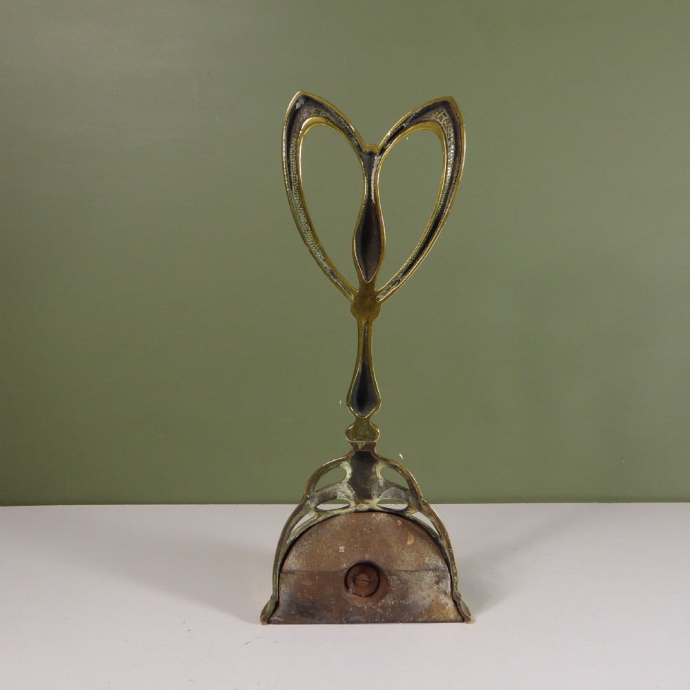 19TH C BRASS DOOR PORTER, DOOR STOP View V