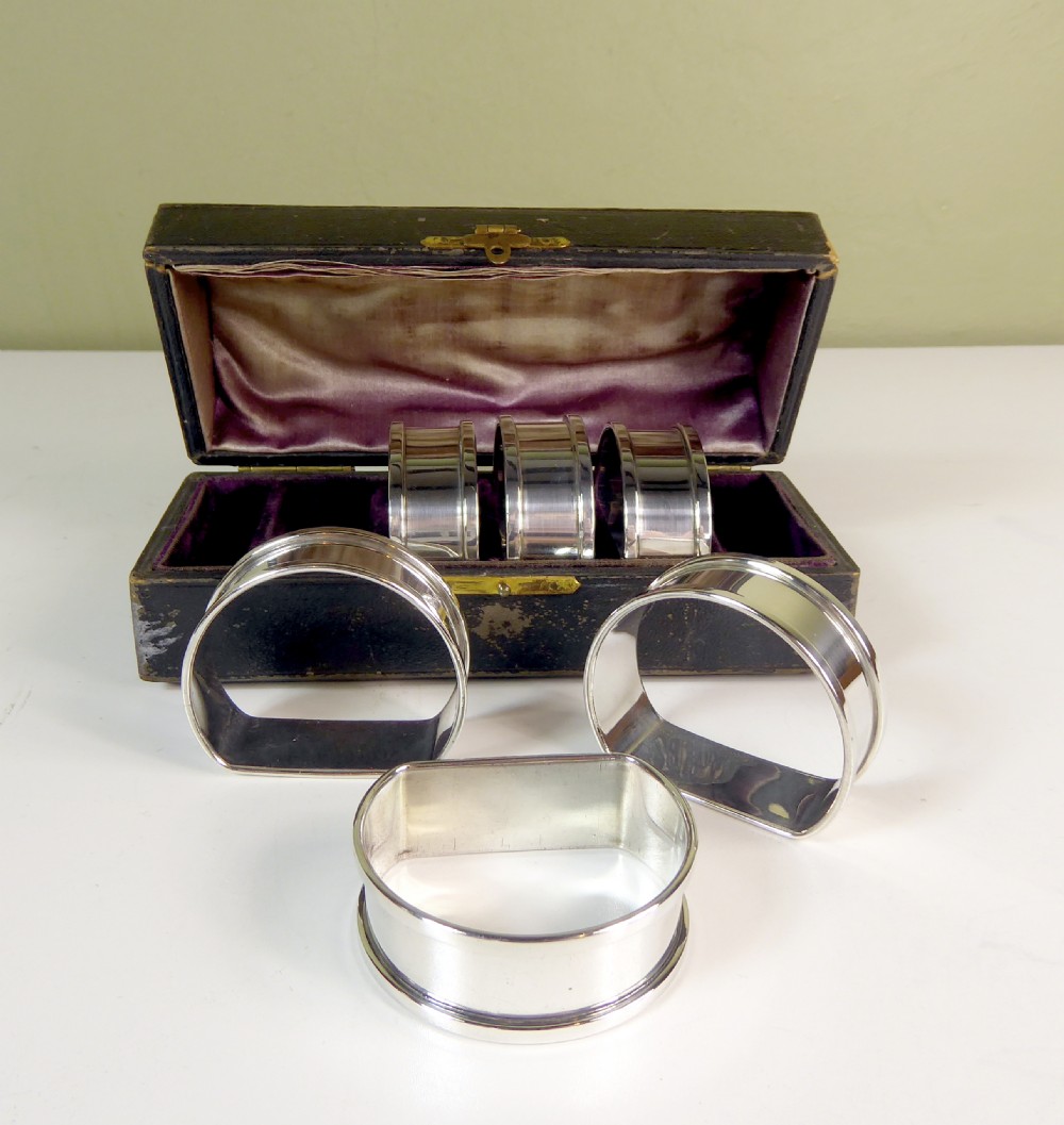 A BOXED SET OF SOLID SILVER NAPKIN RINGS View II