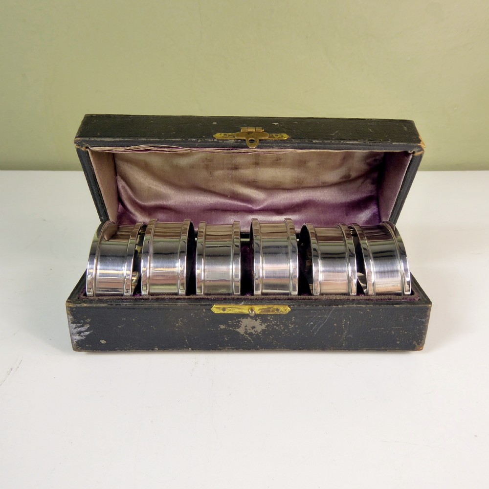 A BOXED SET OF SOLID SILVER NAPKIN RINGS View III