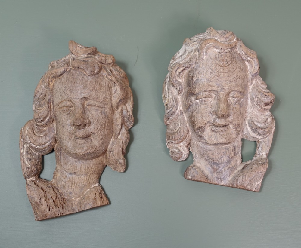 PAIR OF CARVED OAK HEADS 1700