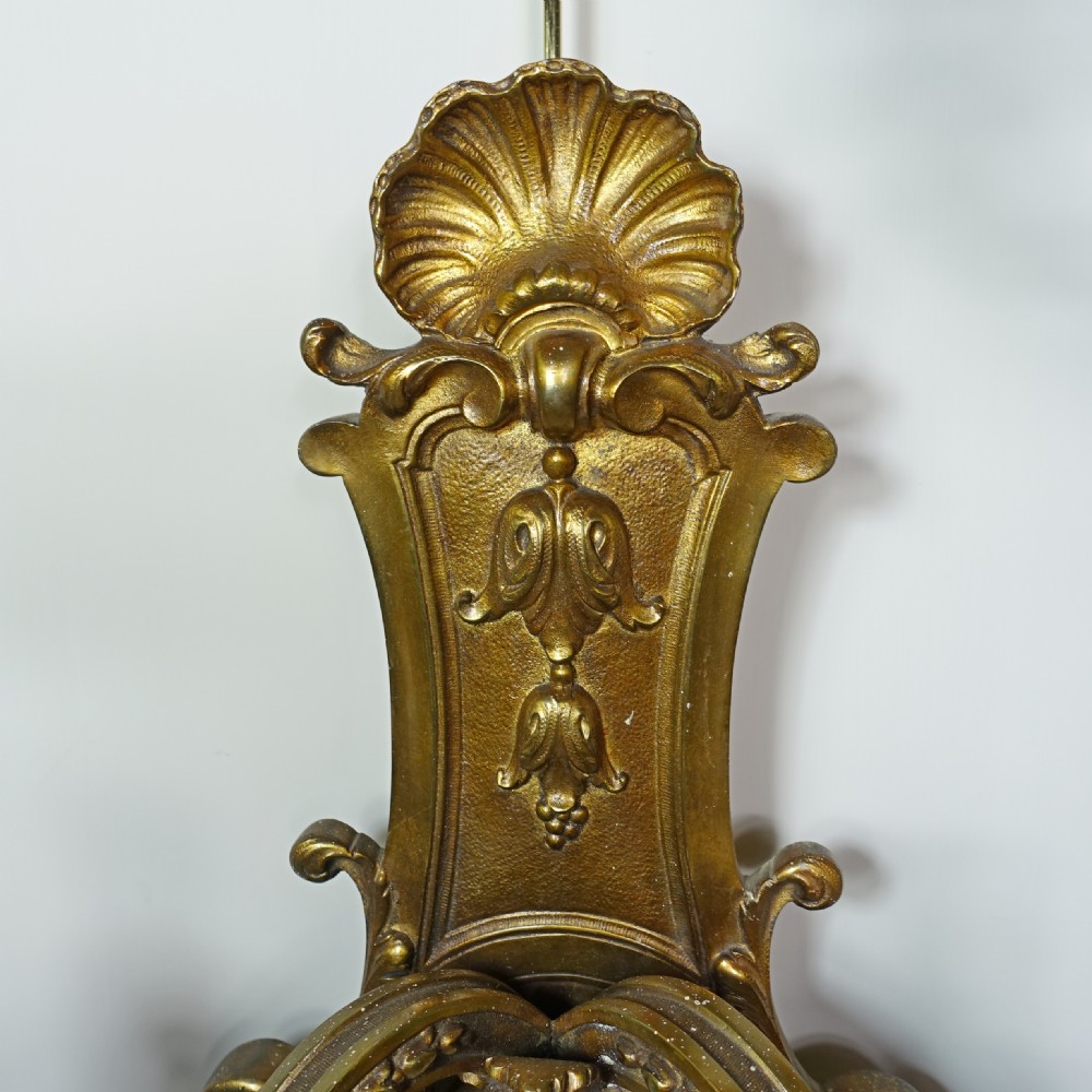 A pair of 19th-century gilt bronze wall sconces, each featuring two scrolling branches, central mascaron face motifs, and shell finials. View III
