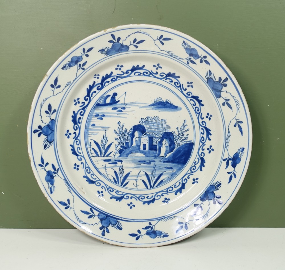 18TH C DELFT CHARGER WITH A LAKE SCENE