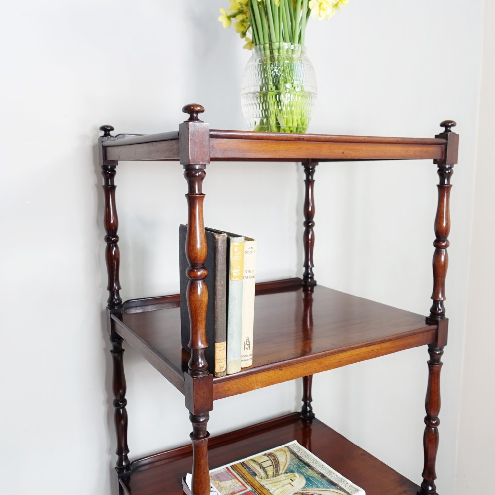 A four-tier Victorian mahogany whatnot featuring turned spindle supports, a single base drawer, and brass castors. View III