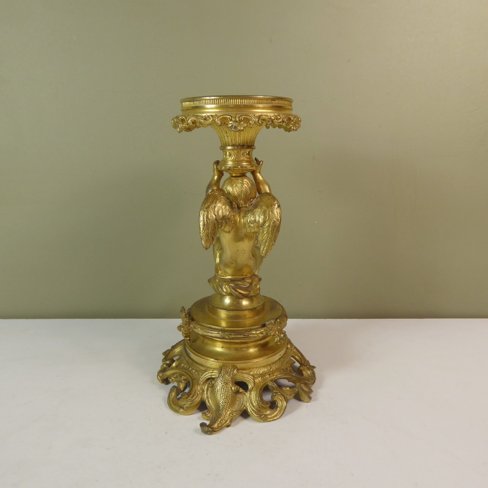 A 19th-century gilt bronze ormolu tazza base featuring a winged cherub figure supporting a fluted capital above a rococo scrolled pedestal. View III