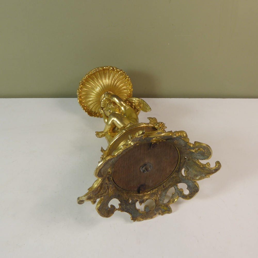 A 19th-century gilt bronze ormolu tazza base featuring a winged cherub figure supporting a fluted capital above a rococo scrolled pedestal. View VII