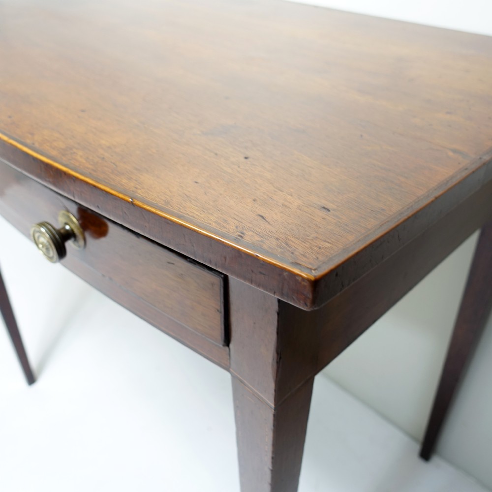 An early 19th-century mahogany side table featuring a single frieze drawer with circular brass handles and tapered legs. View III