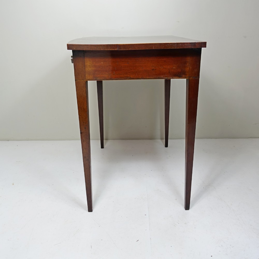 An early 19th-century mahogany side table featuring a single frieze drawer with circular brass handles and tapered legs. View VII
