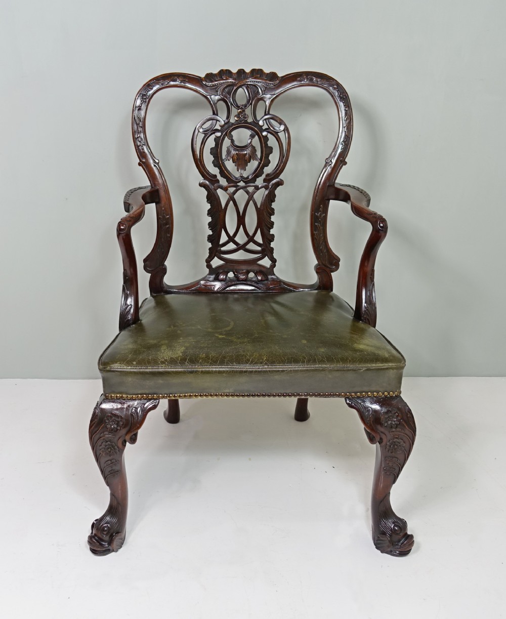 CARVED MAHOGANY OPEN ARM CHAIR