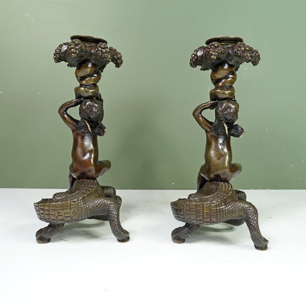 PAIR OF REGENCY BRONZE CANDLESTICKS OF CHERUBS ON CROCODILES View III