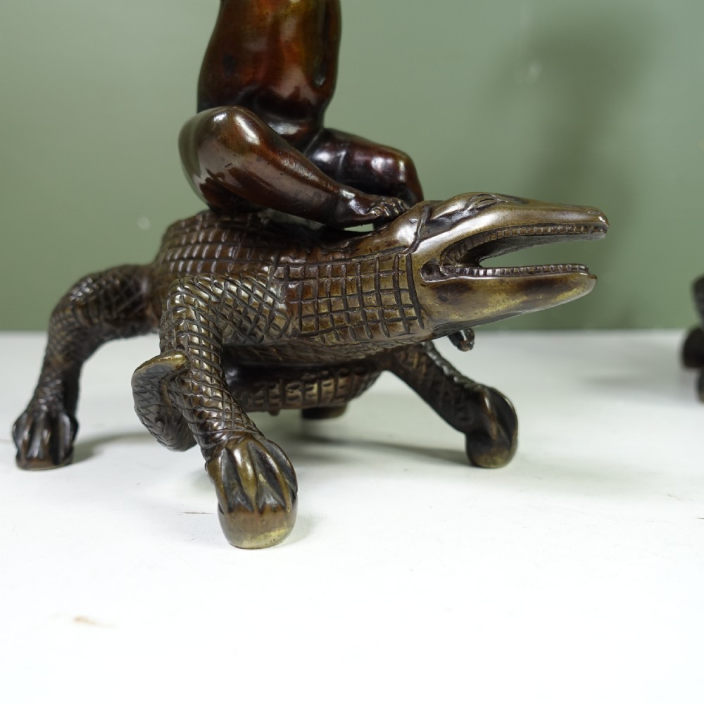PAIR OF REGENCY BRONZE CANDLESTICKS OF CHERUBS ON CROCODILES View IV