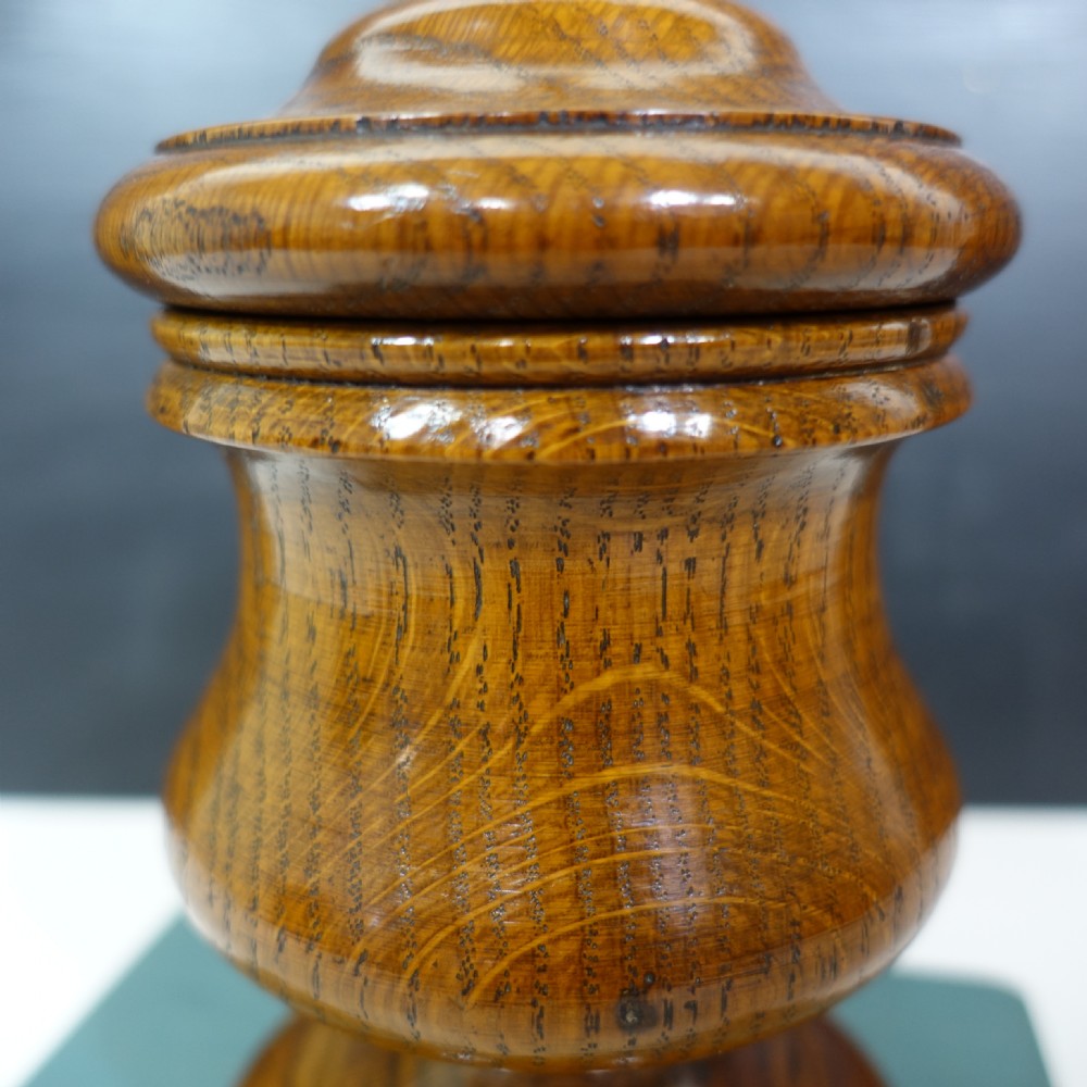 A turned 19th-century wooden lidded vase featuring a stepped pedestal base, baluster body, and fitted cover with a acorn finial. View IV
