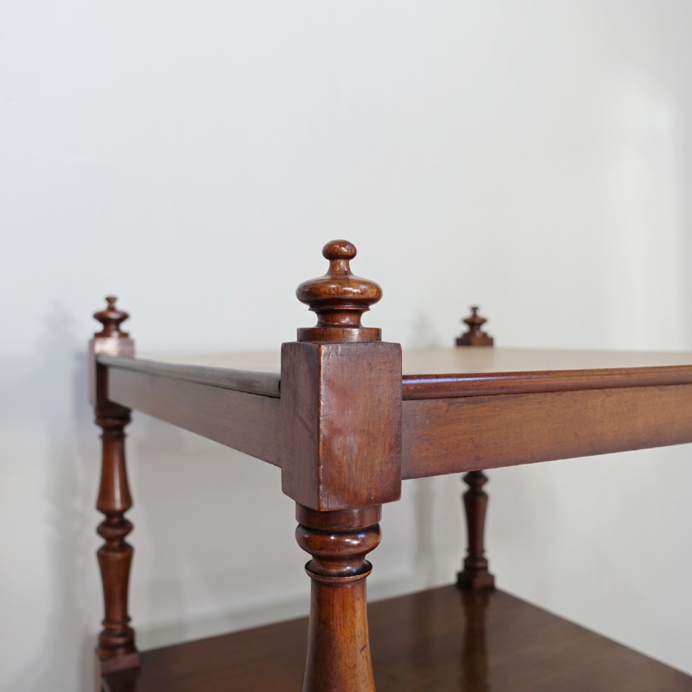 A four-tier mahogany whatnot featuring slender turned spindle supports, top corner finials, and a single drawer at the base with wooden knob handles. View VII