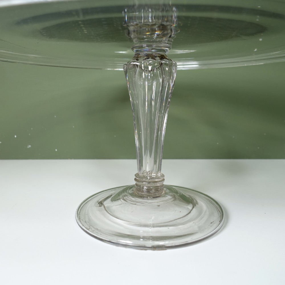 An early nineteenth-century hand-blown clear glass tazza featuring a folded rim, ribbed stem, and circular domed base. View III