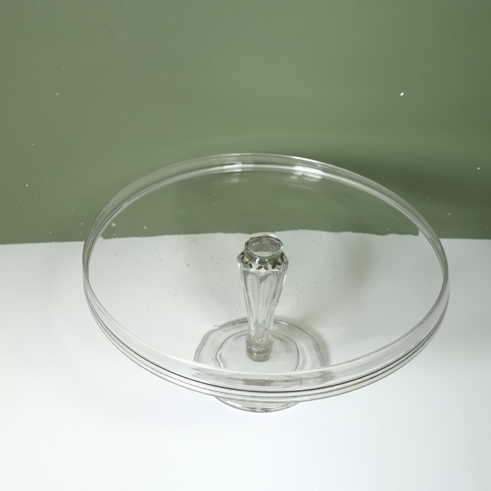 An early nineteenth-century hand-blown clear glass tazza featuring a folded rim, ribbed stem, and circular domed base. View IV