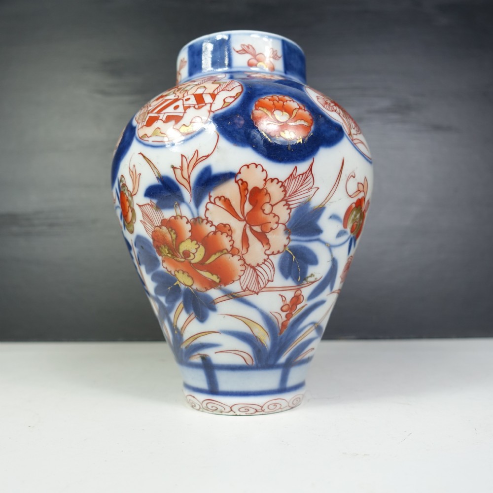 A 19th-century Japanese Imari porcelain vase featuring hand-painted floral motifs and landscape cartouches in cobalt blue, iron-red, and orange enamels. View III