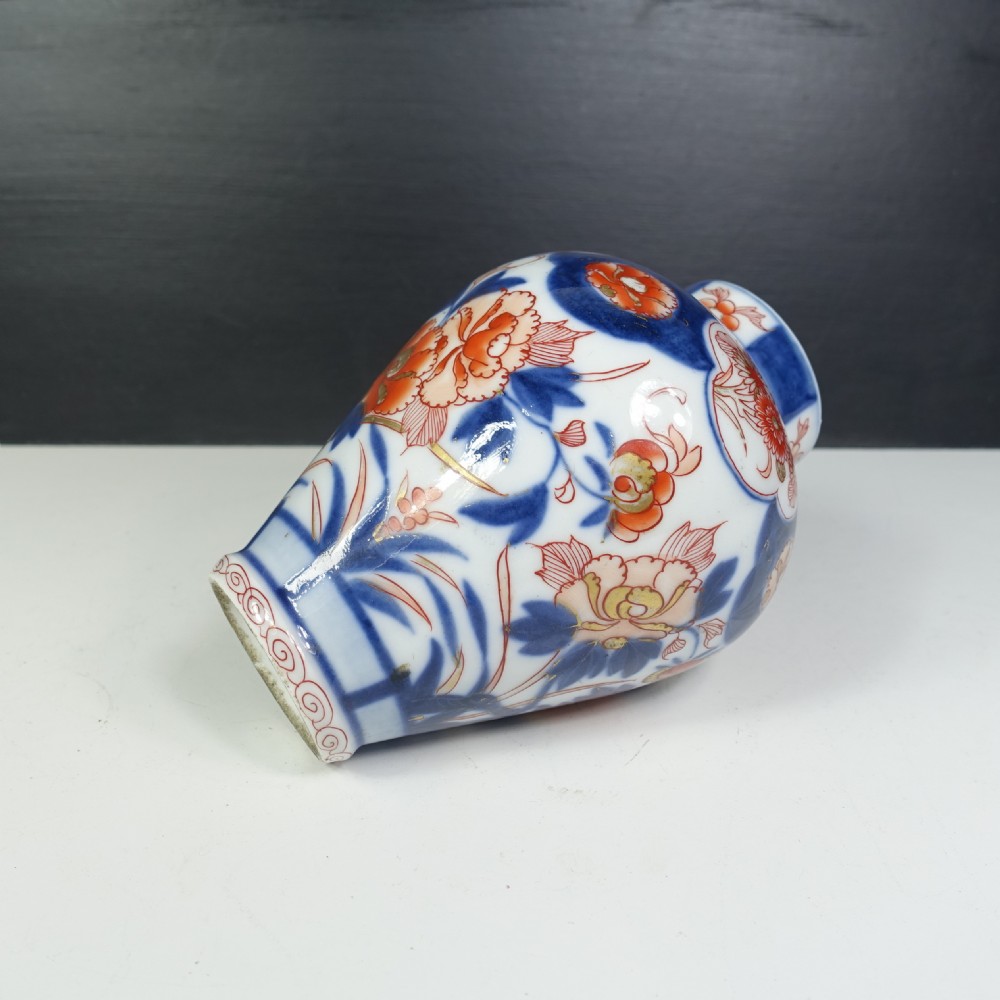 A 19th-century Japanese Imari porcelain vase featuring hand-painted floral motifs and landscape cartouches in cobalt blue, iron-red, and orange enamels. View VI