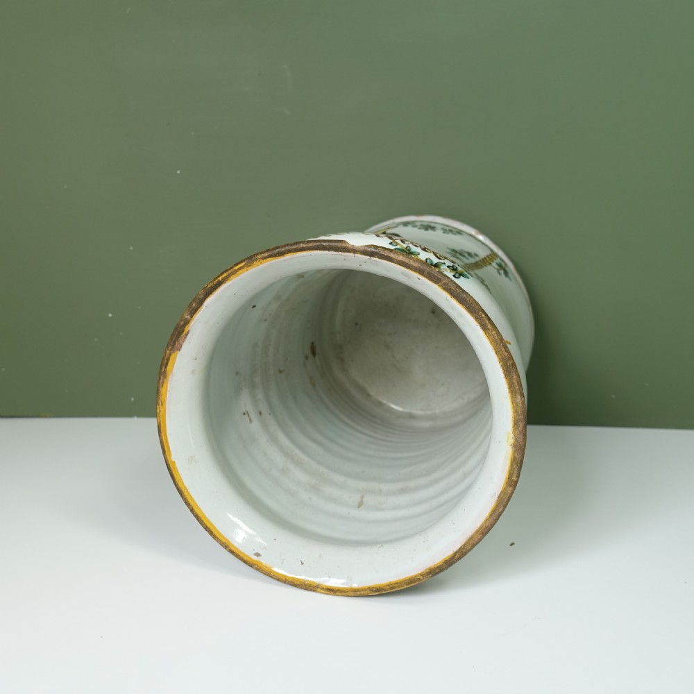 An eighteenth-century cylindrical white tin-glazed earthenware vase featuring a hand-painted floral urn motif and beaded border. View IX