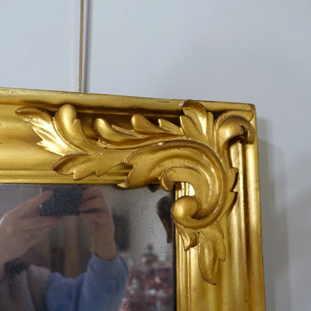 A horizontal 19th-century rectangular mirror with a gold giltwood frame accented by acanthus leaf corner mouldings. View IV