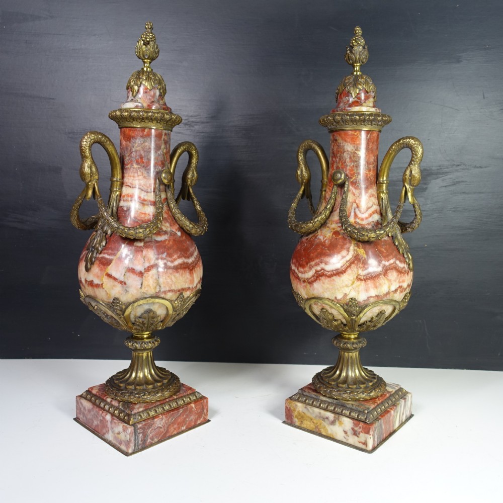 A pair of 19th-century French red veined marble vases with gilded bronze handles and decorative leaf finials set on square plinth bases. View III