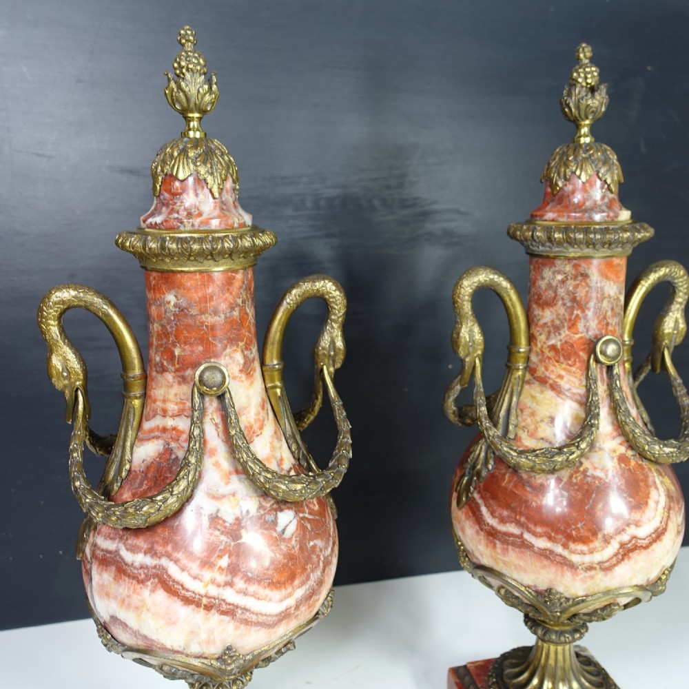 A pair of 19th-century French red veined marble vases with gilded bronze handles and decorative leaf finials set on square plinth bases. View IV