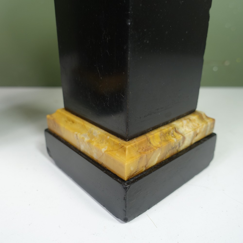 A pair of 19th-century Neoclassical black marble tazzas set on square pedestal bases accented with yellow sienna marble layers. View VI