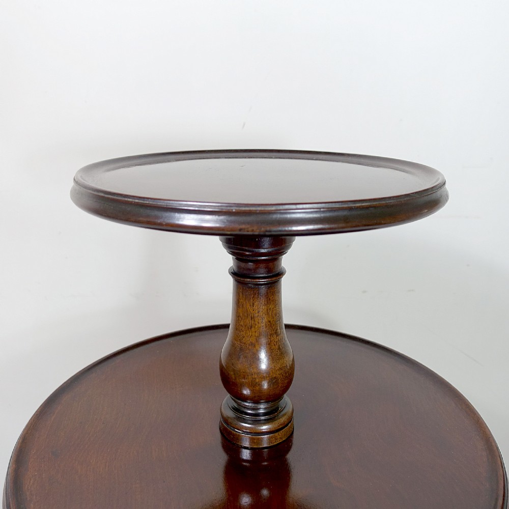 An 18th-century mahogany dumb waiter table featuring three graduated circular tiers supported by turned columns on a tripod base with castors. View III