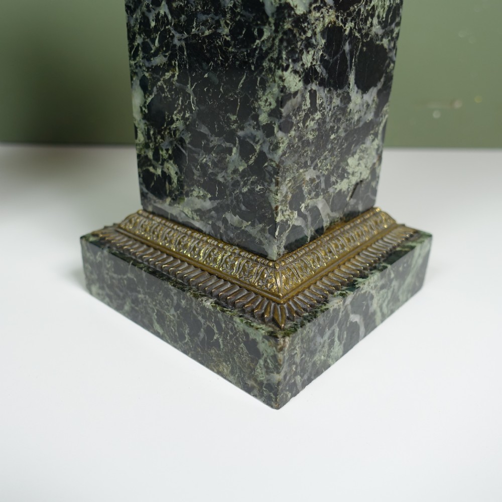 A pair of early 19th-century patinated bronze urns with gilt scroll handles, raised on dark green marble plinths. View VI