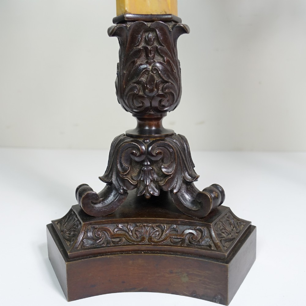 A pair of 19th-century patinated bronze five-light candelabra featuring yellow marble shafts and ornate scrollwork bases. View VII