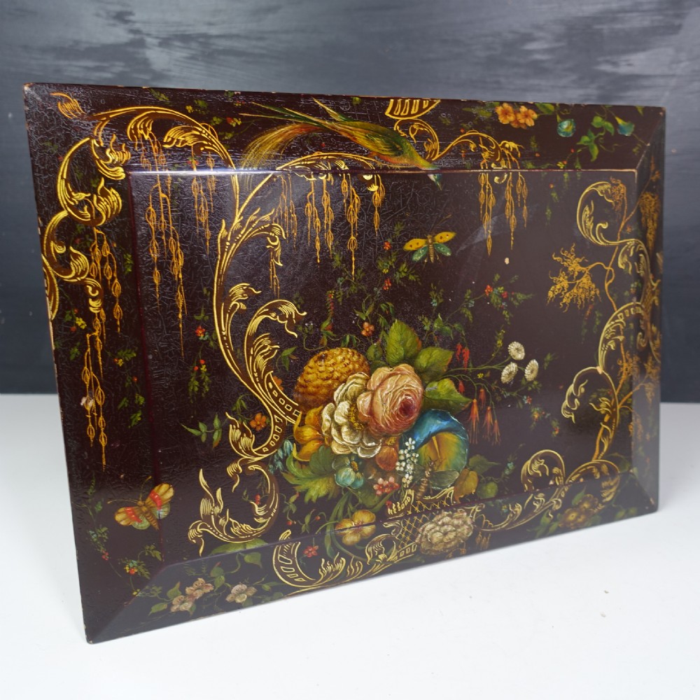 A 19th-century dark brown wooden box decorated with painted floral patterns, birds, gilt scrollwork, and a metal keyhole. View II