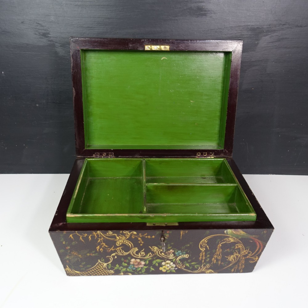 A 19th-century dark brown wooden box decorated with painted floral patterns, birds, gilt scrollwork, and a metal keyhole. View III