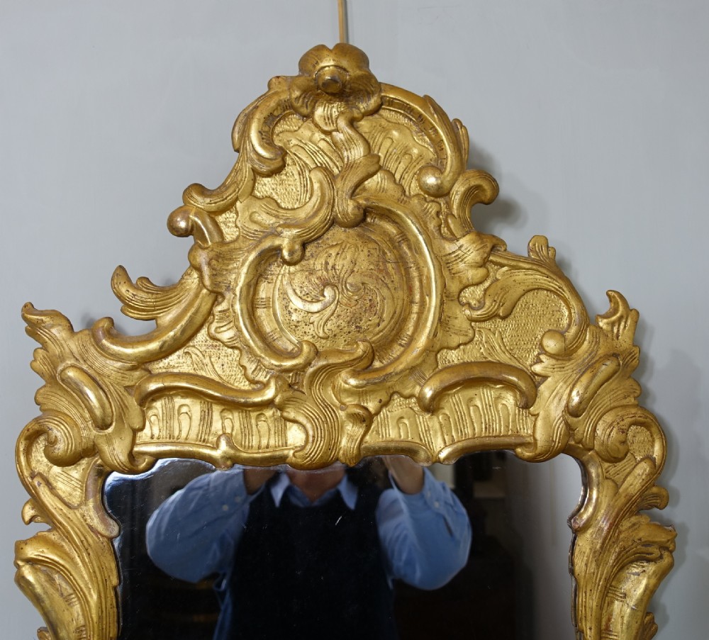 A tall nineteenth-century Rococo Revival wall mirror featuring an ornate gilded wood frame with elaborate scrollwork and acanthus leaf cresting. View II