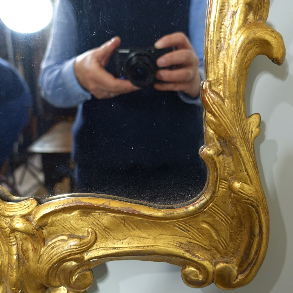 A tall nineteenth-century Rococo Revival wall mirror featuring an ornate gilded wood frame with elaborate scrollwork and acanthus leaf cresting. View VI