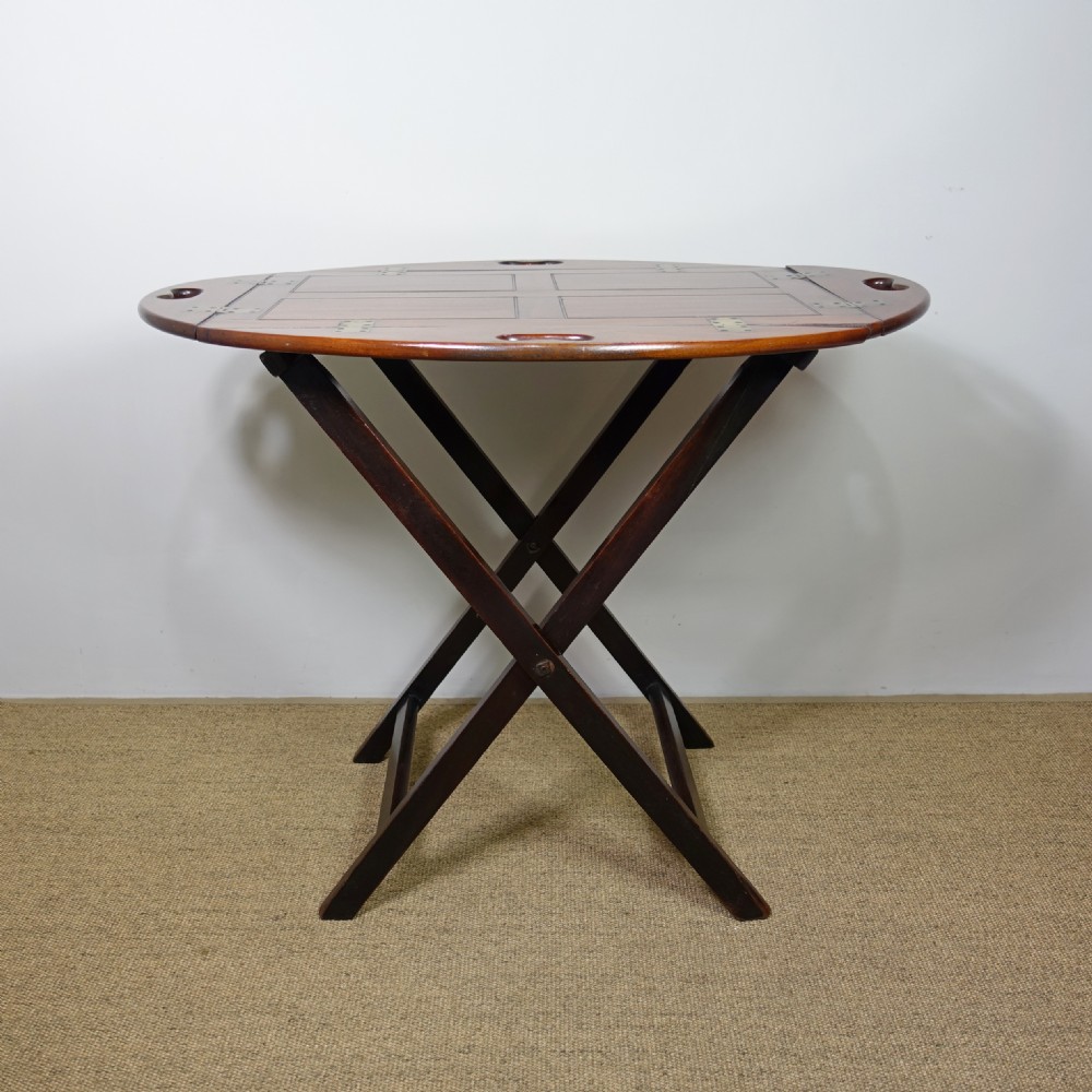 A George III mahogany butlers tray with hinged gallery sides resting on a folding cross-frame stand. View II