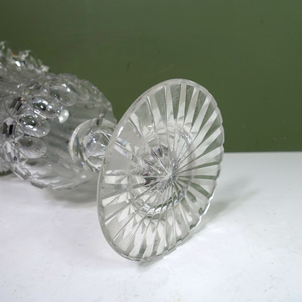 A 19th-century clear cut glass vase featuring a flared scalloped rim, geometric diamond patterns, fluted sides, and a stemmed pedestal base. View VI