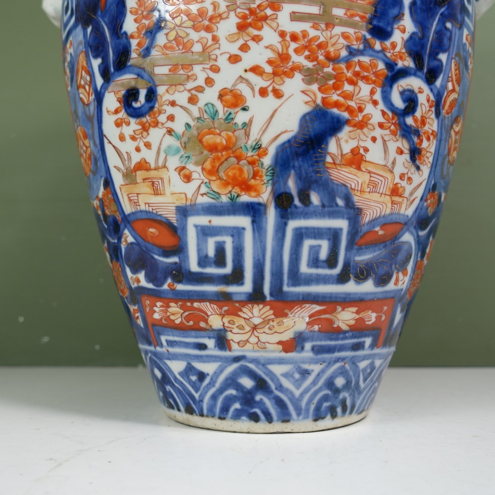 A 19th-century Japanese Imari porcelain vase featuring blue, iron-red, and orange hand-painted floral decoration and side handles. View III