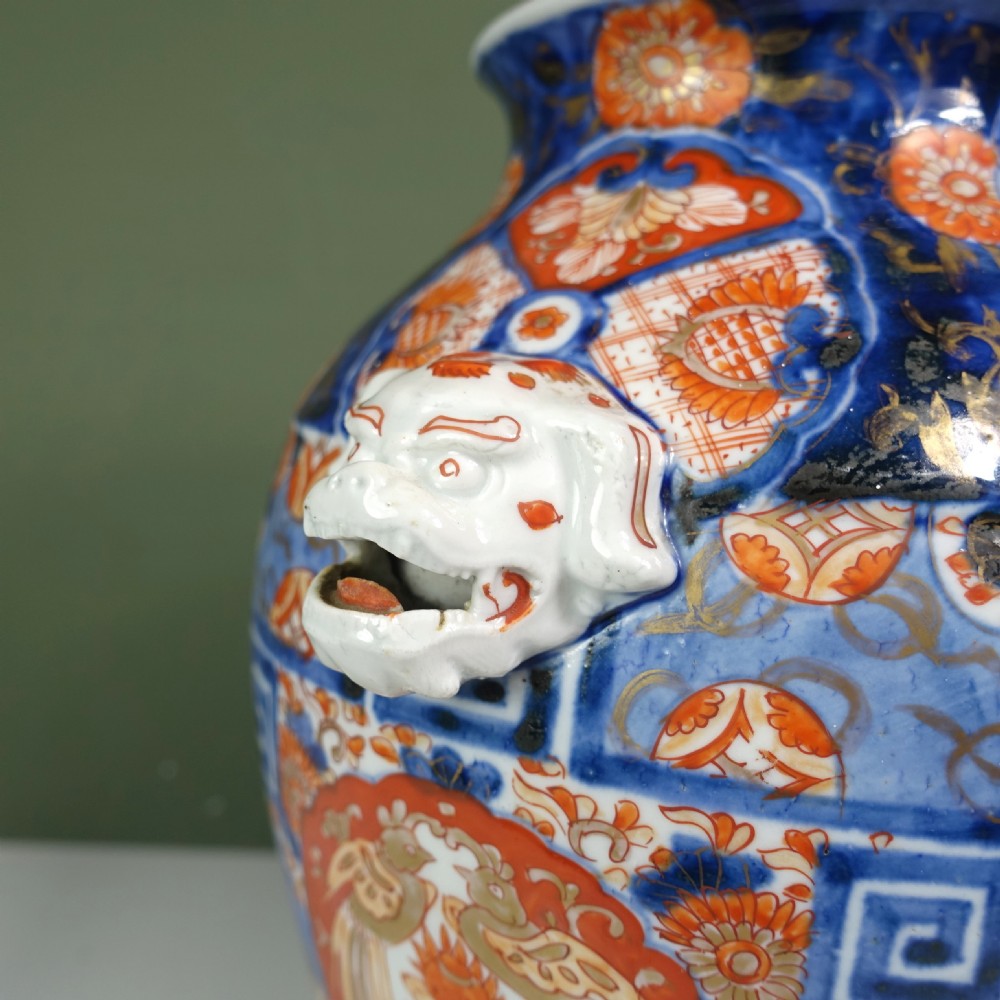 A 19th-century Japanese Imari porcelain vase featuring blue, iron-red, and orange hand-painted floral decoration and side handles. View VIII
