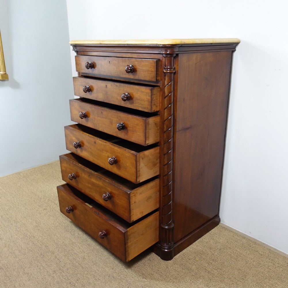 A 19th-century mahogany chest of drawers featuring six stacked drawers, turned wooden knobs, spiral twist side columns, and a smooth marble top. View VI