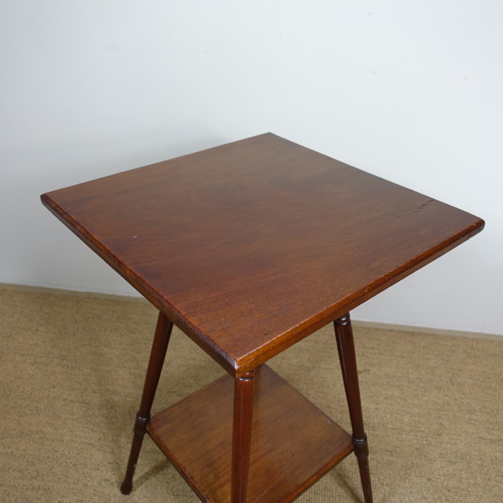 A late 19th-century mahogany occasional table featuring a square top, turned splayed legs, and a square lower undertier shelf. View VI