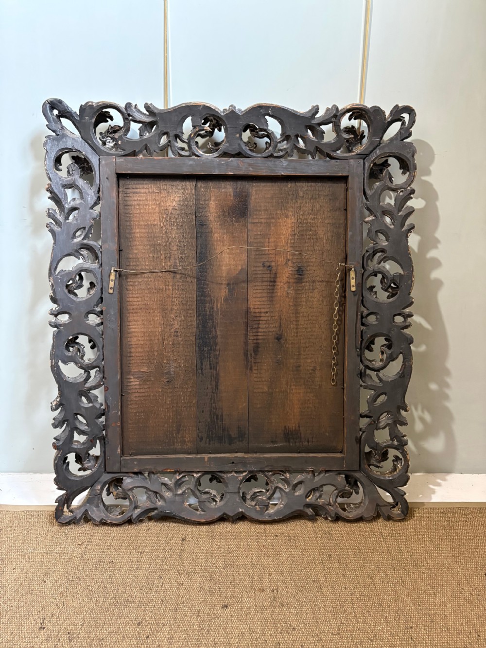 A rectangular 19th-century wall mirror set within a heavy carved giltwood frame featuring pierced scrollwork and acanthus leaf carving. View X